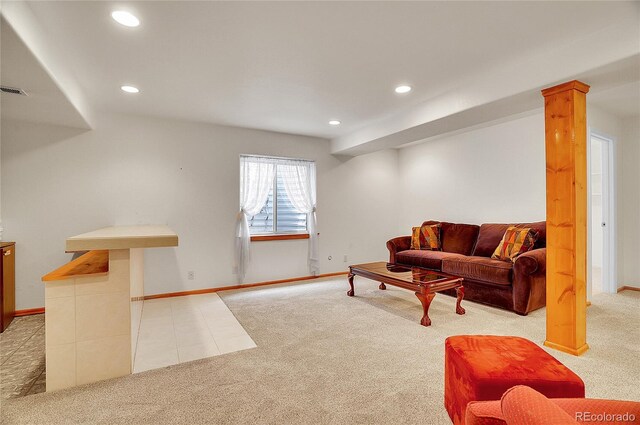 carpeted living area with baseboards, ornate columns, tile patterned flooring, and recessed lighting