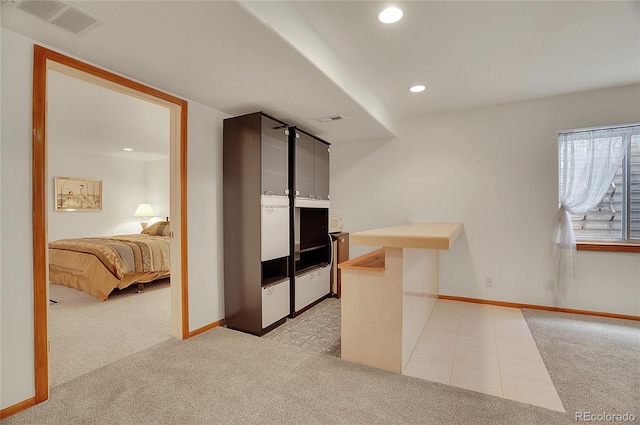 interior space with recessed lighting, visible vents, baseboards, and light colored carpet