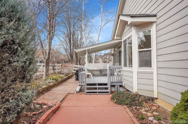 wooden deck with fence and a sunroom