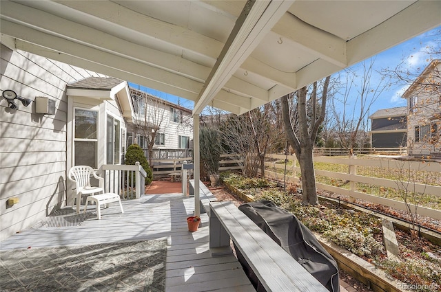 wooden terrace featuring a grill and fence