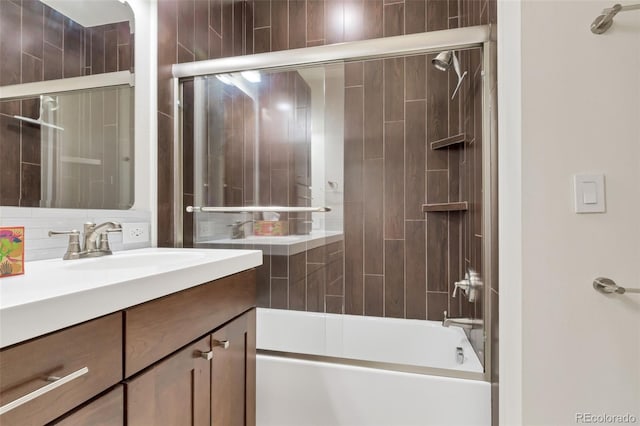 bathroom with vanity and shower / bath combination with glass door