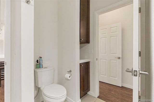 bathroom featuring vanity, wood-type flooring, and toilet