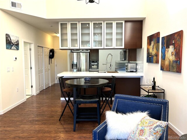 1000 E 1st Ave Unit 405, Denver, CO 80218 - kitchen featuring a sink, stainless steel fridge with ice dispenser, light countertops, a peninsula, and visible vents