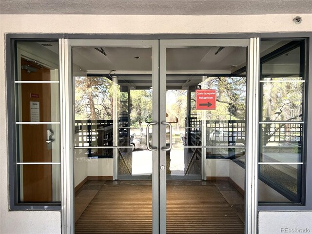 1000 E 1st Ave Unit 405, Denver, CO 80218 - doorway to outside with baseboards, plenty of natural light, and french doors