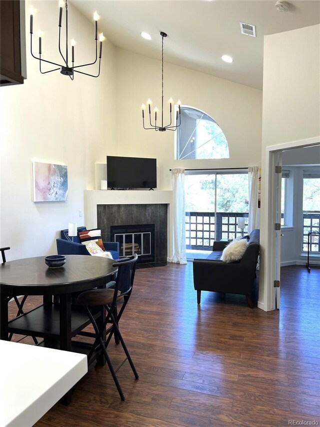 1000 E 1st Ave Unit 405, Denver, CO 80218 - dining room featuring visible vents, a high ceiling, a chandelier, and dark wood-style floors