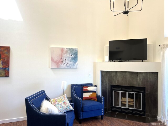 1000 E 1st Ave Unit 405, Denver, CO 80218 - living area featuring an inviting chandelier, wood finished floors, and a tile fireplace