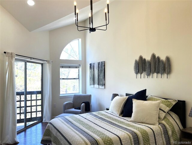 1000 E 1st Ave Unit 405, Denver, CO 80218 - bedroom with a chandelier, access to exterior, wood finished floors, and multiple windows