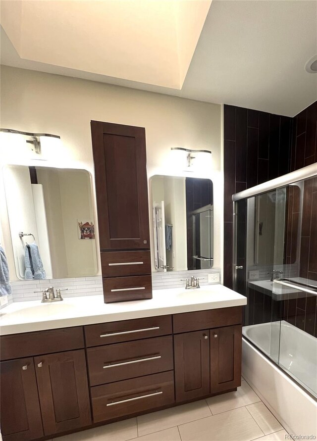 1000 E 1st Ave Unit 405, Denver, CO 80218 - bathroom featuring double vanity, tile patterned floors, a sink, and bath / shower combo with glass door