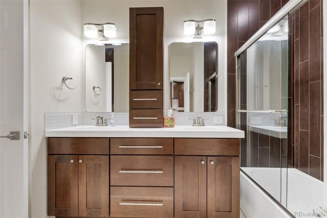 1000 E 1st Ave Unit 405, Denver, CO 80218 - full bath with backsplash, double vanity, a sink, and shower / bath combination with glass door