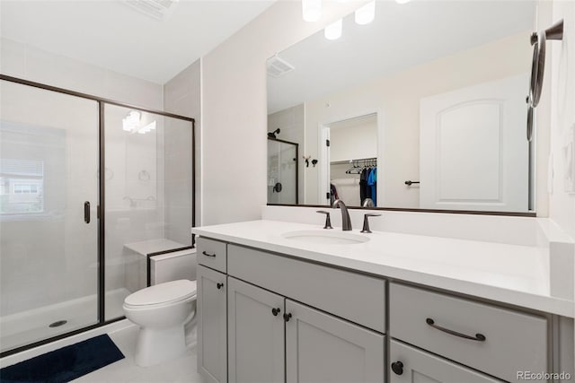 5745 S Buchanan Ct Unit C, Aurora, CO 80016 - bathroom featuring vanity, a shower stall, a spacious closet, and tile patterned floors