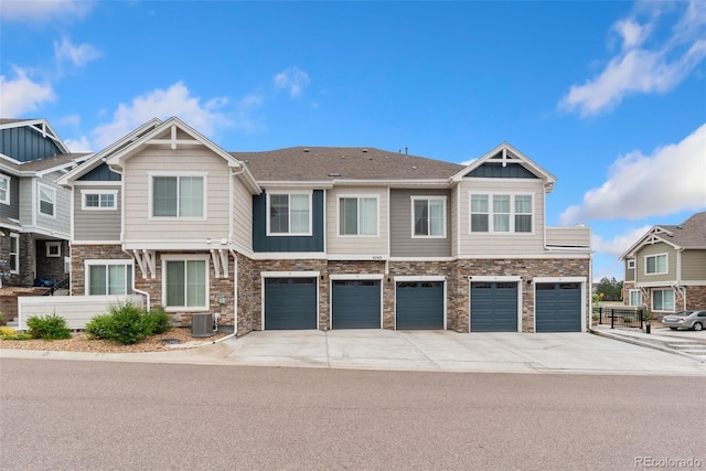 5745 S Buchanan Ct Unit C, Aurora, CO 80016 - townhome / multi-family property with stone siding, driveway, and a garage