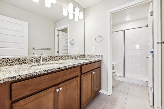 bathroom featuring vanity, tile patterned flooring, toilet, and an enclosed shower