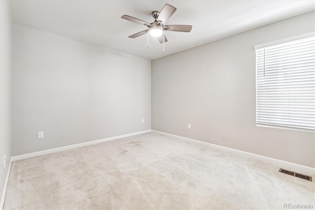 carpeted empty room featuring ceiling fan