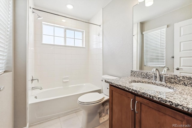 full bathroom featuring vanity, tiled shower / bath combo, toilet, and tile patterned floors