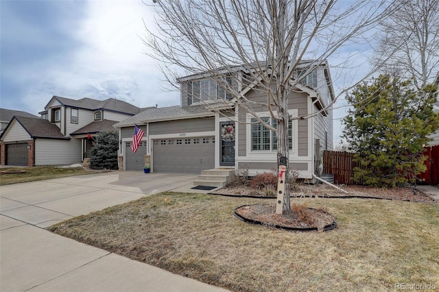 view of front property featuring a garage and a front lawn