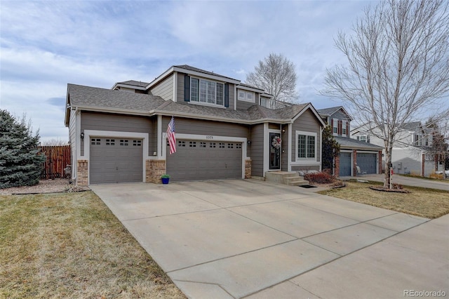 view of front of property featuring a garage and a front lawn