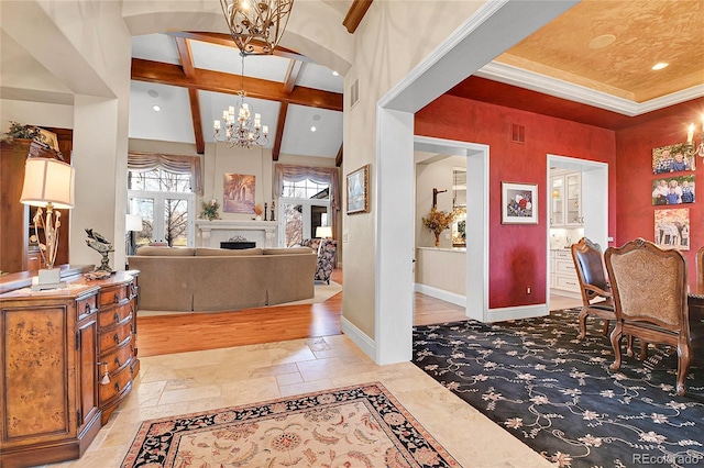 foyer with beam ceiling, a high ceiling, and an inviting chandelier