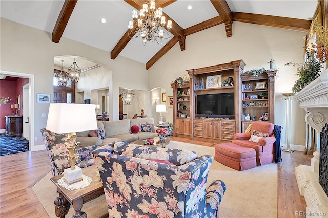 living room with high vaulted ceiling, light hardwood / wood-style flooring, beamed ceiling, and a notable chandelier