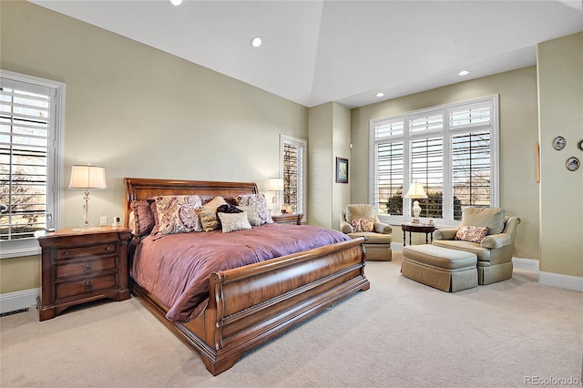 bedroom with light carpet and lofted ceiling