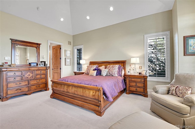 bedroom featuring high vaulted ceiling and light colored carpet