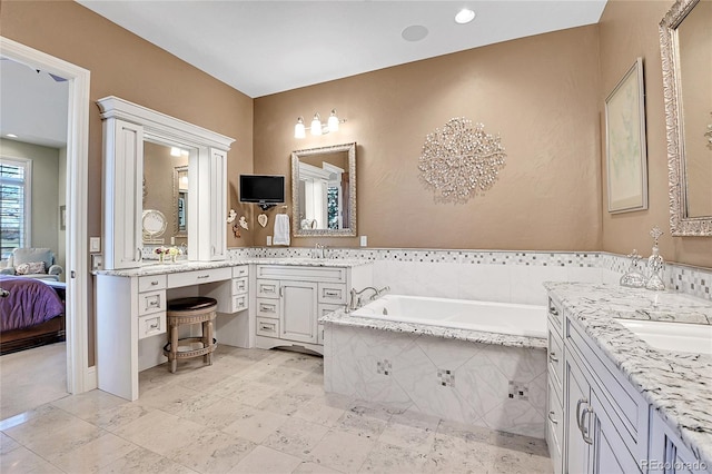 bathroom with tiled bath and vanity