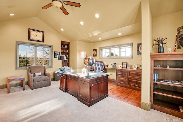 carpeted office space featuring ceiling fan and lofted ceiling