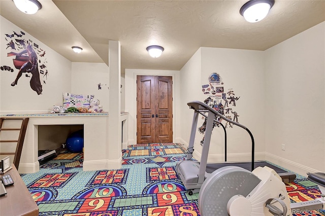 playroom featuring a textured ceiling