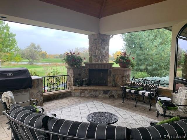 view of patio featuring an outdoor stone fireplace