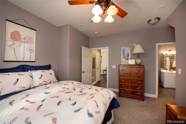 bedroom with sink, carpet floors, ceiling fan, and ensuite bathroom