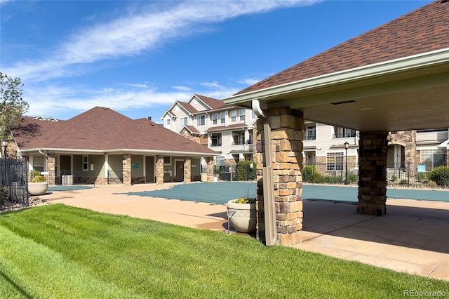 view of swimming pool featuring a patio and a lawn