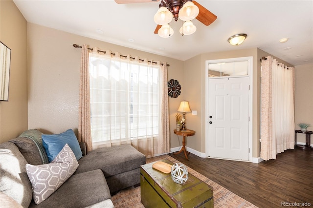 living room with dark hardwood / wood-style floors and ceiling fan