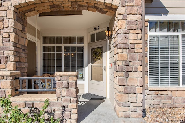 property entrance with stone siding