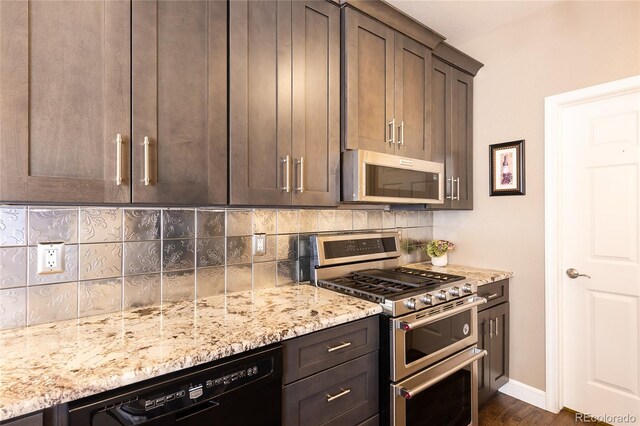 kitchen featuring backsplash, dark brown cabinets, light stone countertops, and appliances with stainless steel finishes