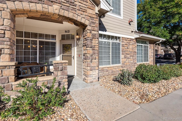 property entrance with stone siding