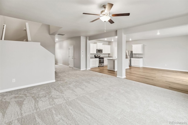 2175 Alyssa St, Fort Lupton, CO 80621 - unfurnished living room with light carpet, baseboards, ceiling fan, and recessed lighting