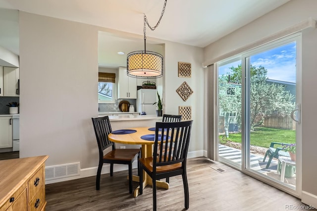 dining area with wood finished floors and baseboards