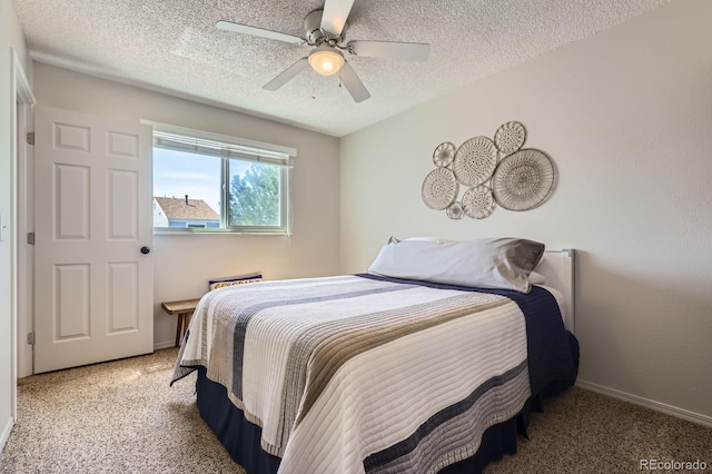 carpeted bedroom with a textured ceiling, ceiling fan, and baseboards