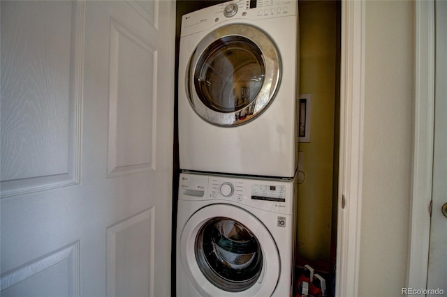 laundry room with laundry area and stacked washer / dryer