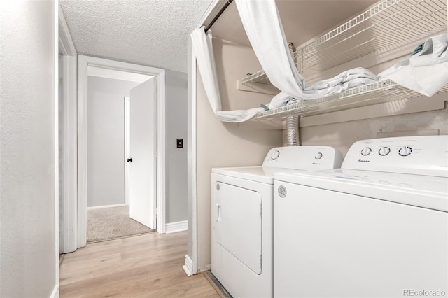 401 S Kalispell Way Unit 104, Aurora, CO 80017 - washroom featuring washing machine and clothes dryer and light wood-style flooring