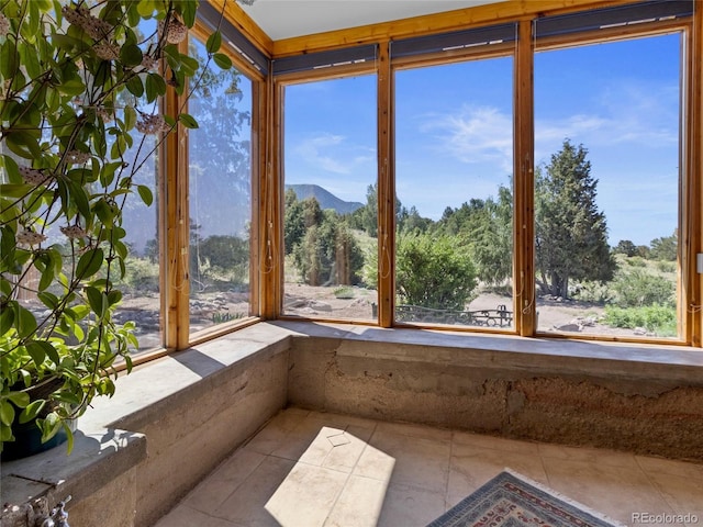 551 Panorama Way, Crestone, CO 81131 - unfurnished sunroom with tile patterned flooring and a mountain view
