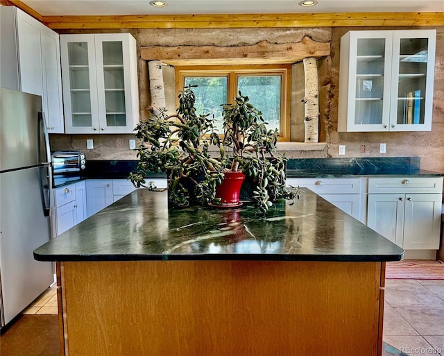 551 Panorama Way, Crestone, CO 81131 - kitchen featuring freestanding refrigerator, a center island, light tile patterned floors, dark countertops, and recessed lighting