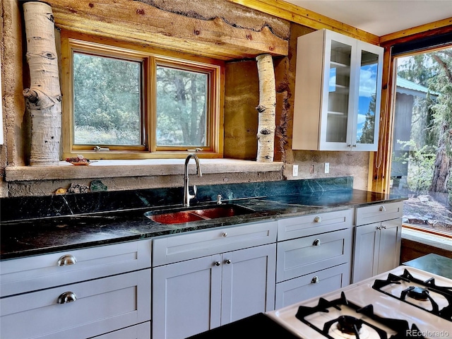 551 Panorama Way, Crestone, CO 81131 - kitchen with glass insert cabinets, white cabinets, and dark stone countertops