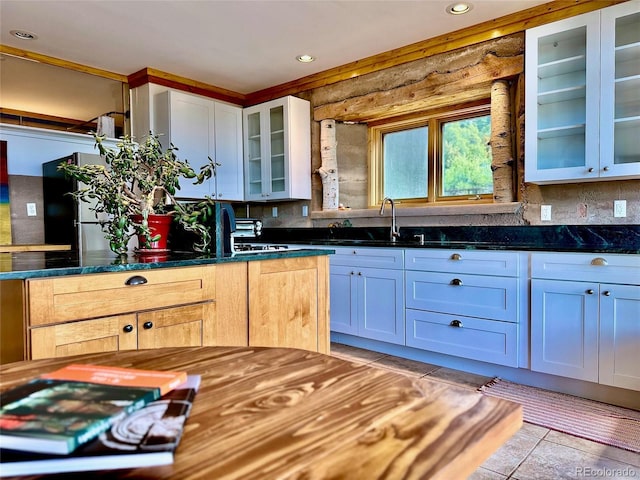 551 Panorama Way, Crestone, CO 81131 - kitchen with glass insert cabinets, recessed lighting, white cabinetry, and dark stone counters
