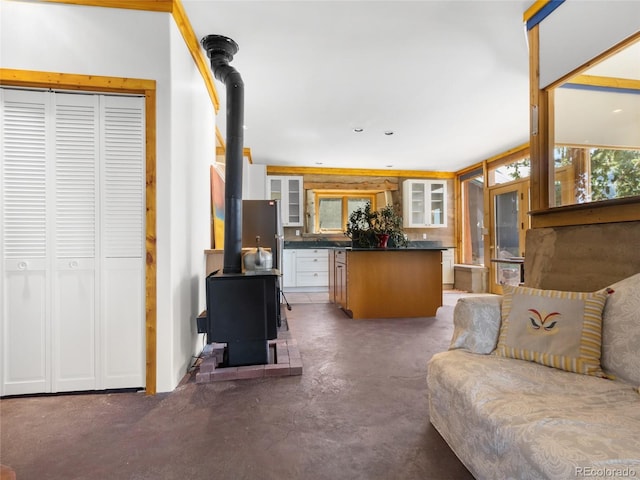 551 Panorama Way, Crestone, CO 81131 - living area featuring a wood stove, finished concrete flooring, and plenty of natural light