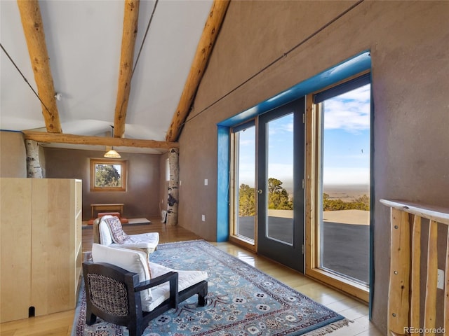 551 Panorama Way, Crestone, CO 81131 - living room with beam ceiling, plenty of natural light, light wood-style flooring, and high vaulted ceiling