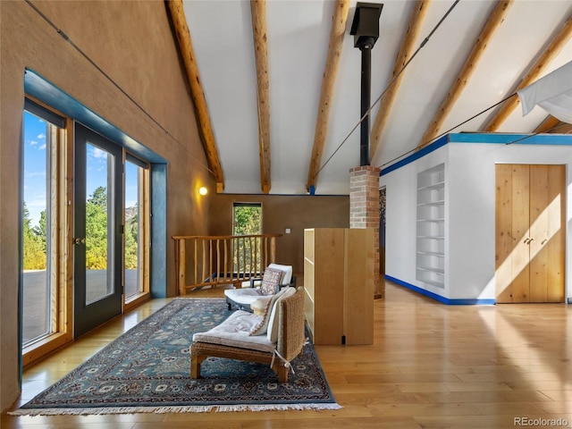 551 Panorama Way, Crestone, CO 81131 - sitting room featuring beamed ceiling, high vaulted ceiling, wood-type flooring, and built in features