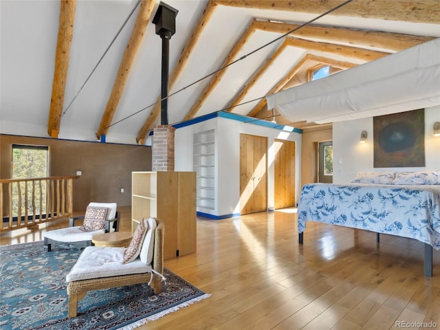551 Panorama Way, Crestone, CO 81131 - bedroom featuring multiple windows, beamed ceiling, high vaulted ceiling, and wood finished floors