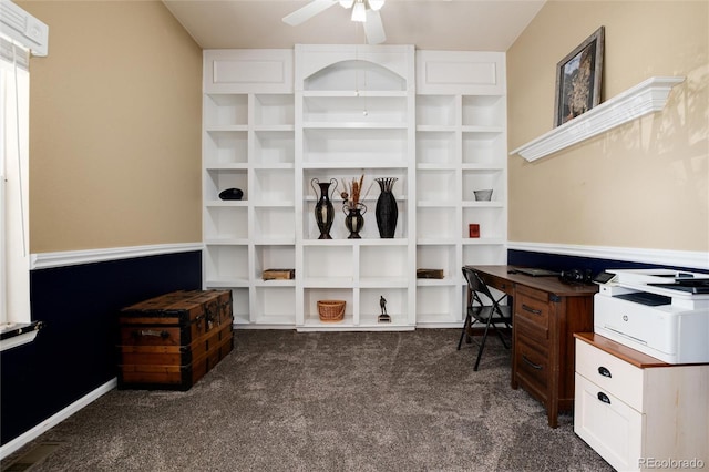home office with dark carpet and ceiling fan