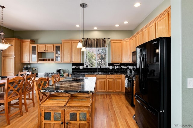 kitchen featuring black appliances, light wood finished floors, light brown cabinetry, and recessed lighting