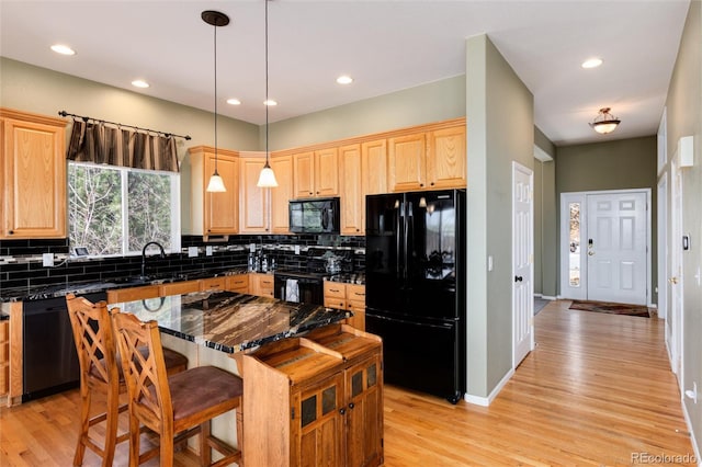 kitchen featuring black appliances, backsplash, light wood finished floors, light brown cabinetry, and recessed lighting